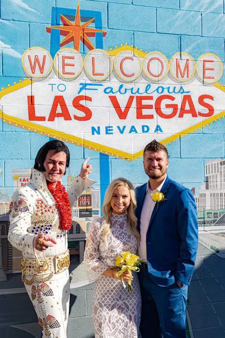 Couple & Elvis posed in front of Welcome to Las Vegas Mural