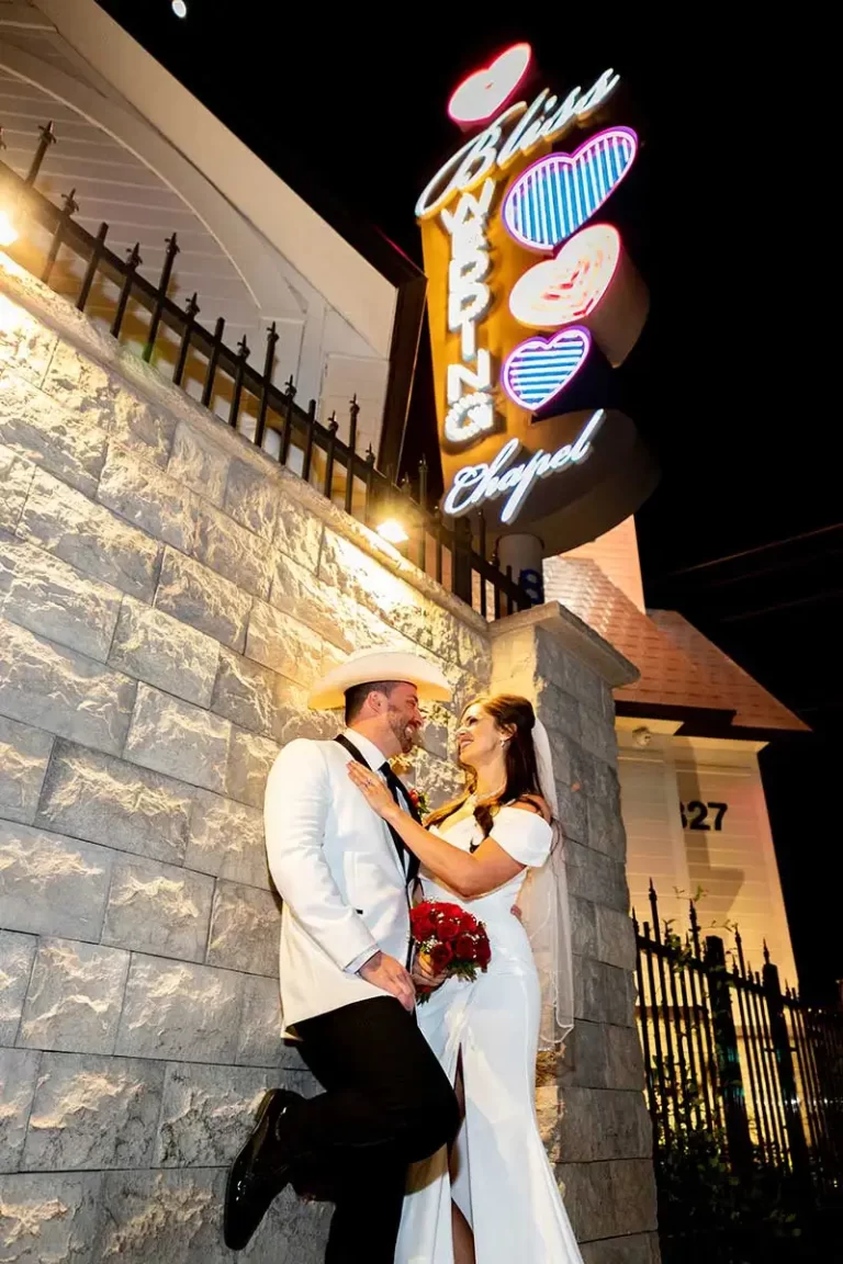 Couple under Bliss Wedding Chapel Sign